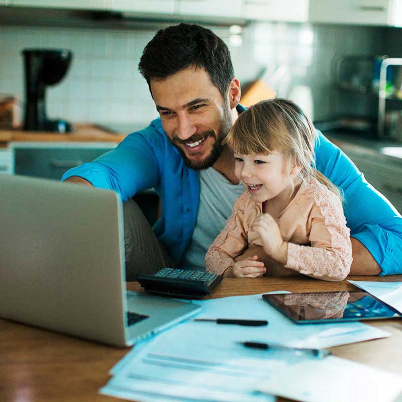 Father and daughter looking at laptop